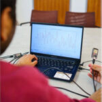 COMPUTER SCIENCE AND ENGINEERING PH.D. STUDENT NAYAN BHATIA DEMONSTRATES PULSE-FI, TECHNOLOGY THAT USES WIFI SIGNALS TO MEASURE A PERSON'S HEART RATE.